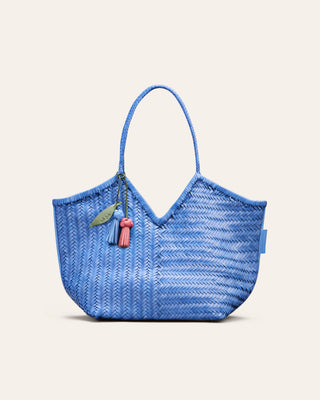 Cala Jade Blue woven handbag with a leather bag charm on a light beige background