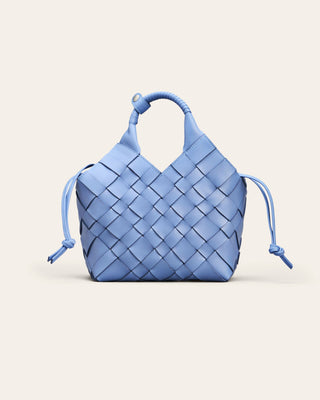 Cala Jade Misu Blue woven shoulder bag on a beige background