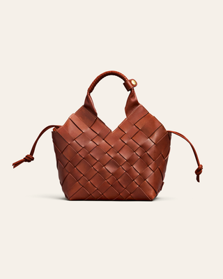 Brown woven handbag on a beige background