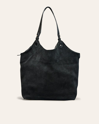 Black leather tote bag on a light beige background