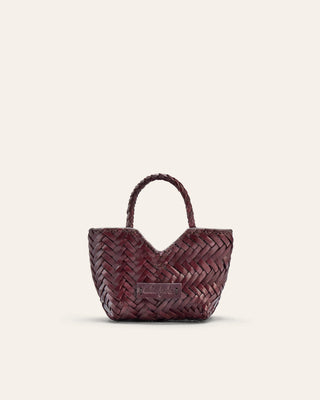 Woven handbag on a light beige background