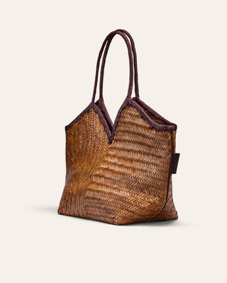 Woven handbag with brown and purple accents on a beige background