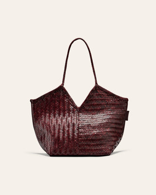 Woven burgundy handbag on a beige background