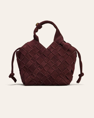 Brown woven handbag on a light beige background