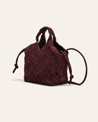 Brown woven handbag on a light beige background