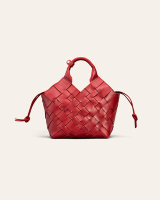 A red woven leather handbag with a top handle and drawstring ties, centered on a light beige background.