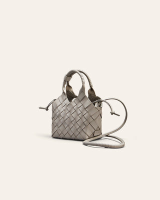 Woven handbag on a light beige background