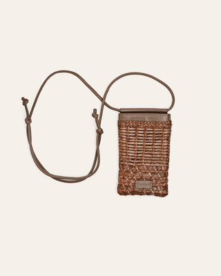 Woven brown leather phone pouch with a strap on a beige background