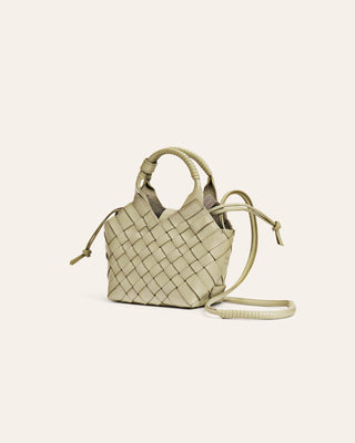 Woven light green handbag on a light beige background