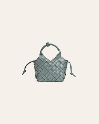 Light blue woven handbag on a light gray background