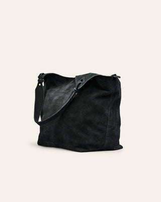 Cala Jade Black leather shoulder bag on a beige background