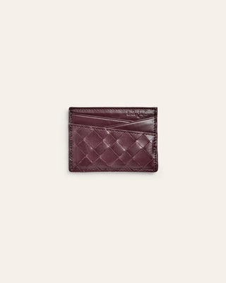 Woven leather cardholder on a light beige background