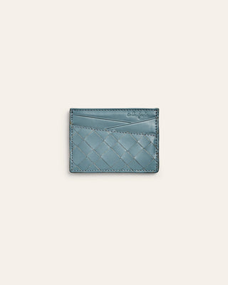 Blue woven cardholder on a light gray background