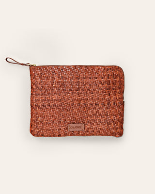 Cala Jade medium sized brown nutmeg leather pouch on a beige background