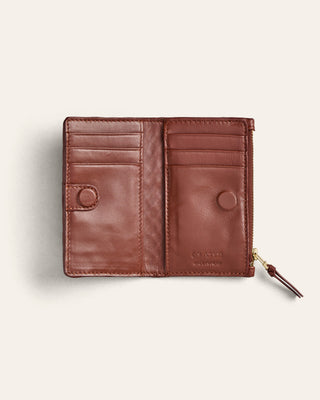 Brown leather wallet on a light beige background