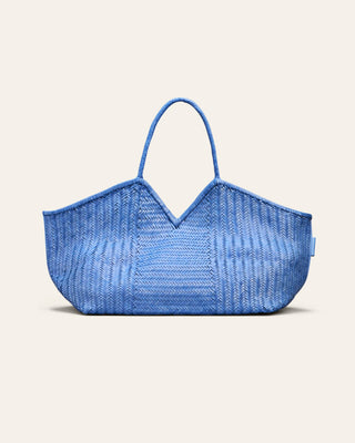 Cala Jade large blue woven leather bag on a beige background