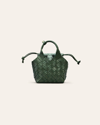 Cala Jade Green woven handbag on a light beige background with a cotton drawstring innerbag