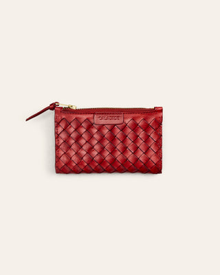 Red woven pouch with a gold zipper on a light beige background