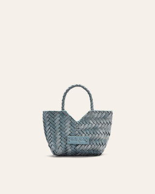 Woven handbag with a visible brand label on a light gray background