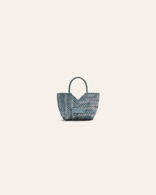 A light blue woven leather bag charm on a beige background