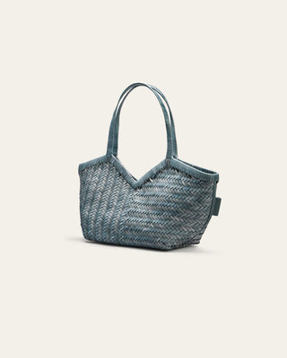 Blue woven handbag on a light gray background