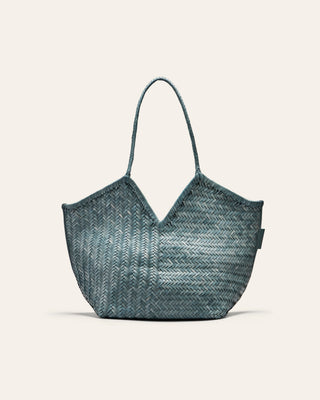 Blue woven handbag on a light beige background