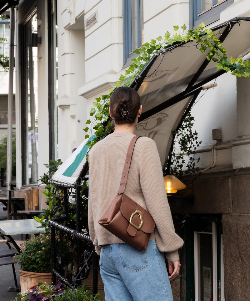 Cala Jade brown leather shoulder bag on a model