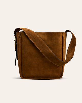 a dark beige shoulder bag seen from the side with a gold buckle