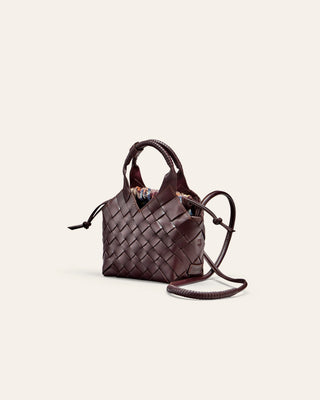Woven brown handbag on a light beige background