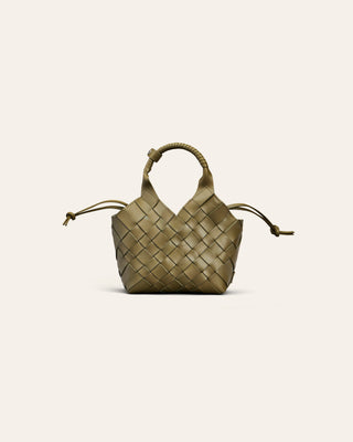 A dark green woen leather handbag on a beige background used for product image