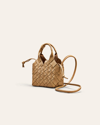 Woven beige handbag on a light beige background
