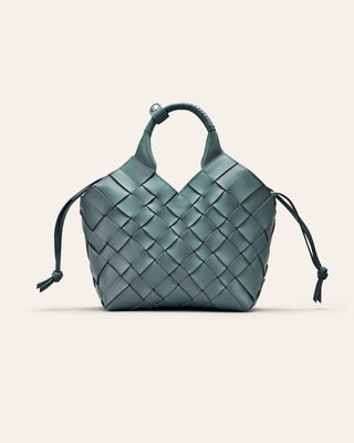 A blue woven handbag on a light gray background