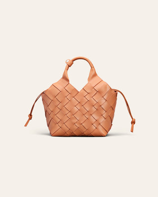 A light orange woven leather bag on a beige background