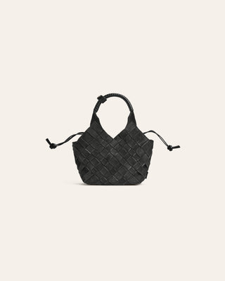 Dark green suede woven handbag on a beige background