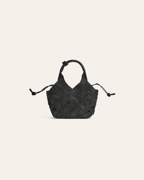 Dark green suede woven handbag on a beige background