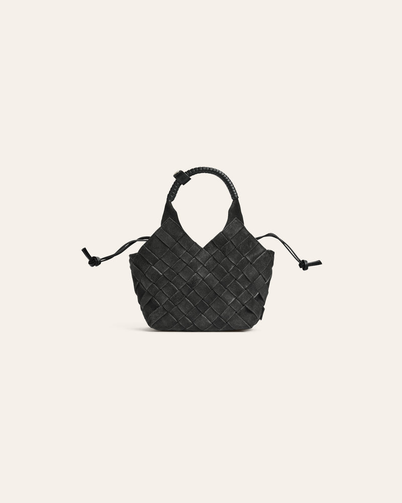 Dark green suede woven handbag on a beige background