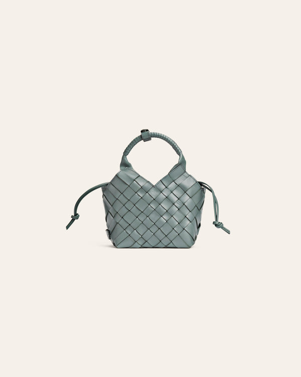 Light blue woven handbag on a light gray background