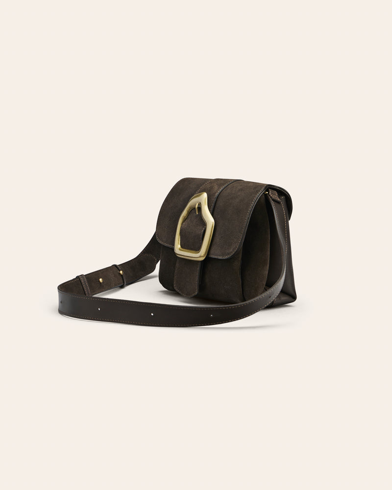 Brown suede shoulder bag with gold buckle on beige background