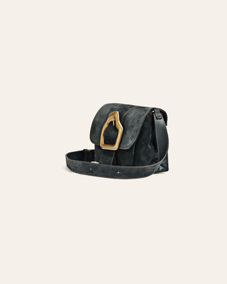 Green suede leather bag with a gold buckle on a light beige background