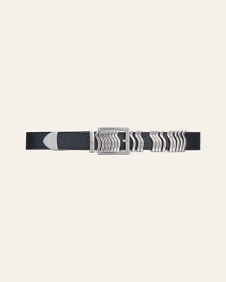 A black leather belt with silver details on a beige background